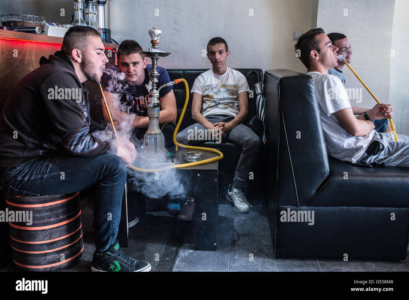 Some young men smoke tobacco by narghilè in a coffee shop of Travnik, Bosnia Erzegovina, Europe Stock Photo