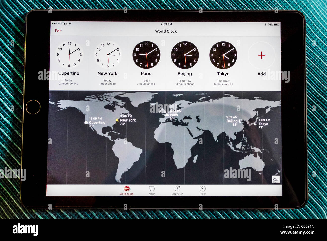A map and clocks showing time across the world. Seen on an iPad Air. USA. Stock Photo