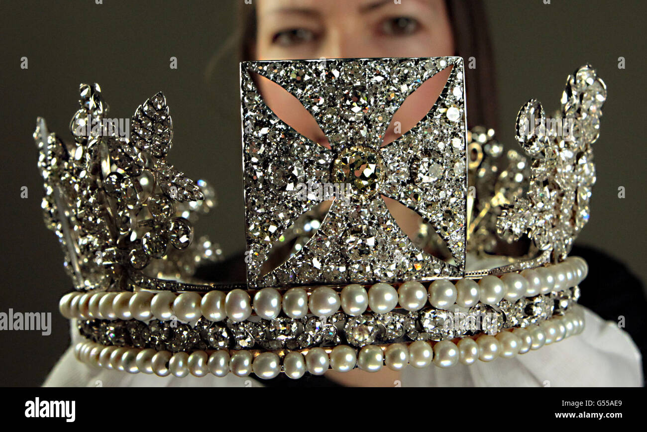 Royal Collection Curator Caroline de Guitaut holds the Diamond Diadem, crown familiar to millions after being worn by the Queen on postage stamps, which is to go on display at Buckingham Palace, London. Stock Photo