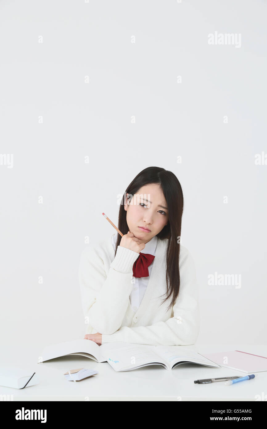 Japanese High-school student in uniform against white background Stock Photo
