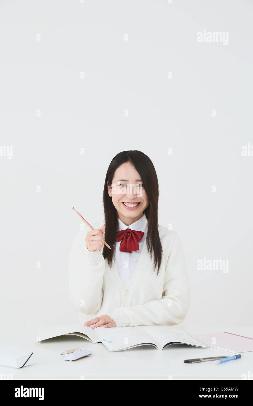 Japanese High-school student in uniform against white background Stock Photo