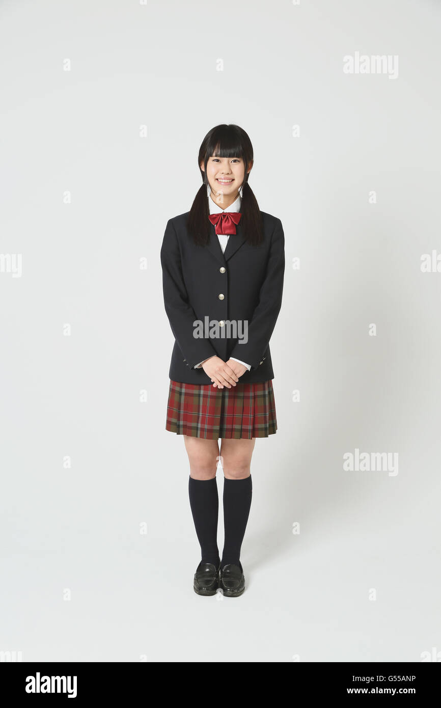 Japanese Highschool student in uniform against white background Stock