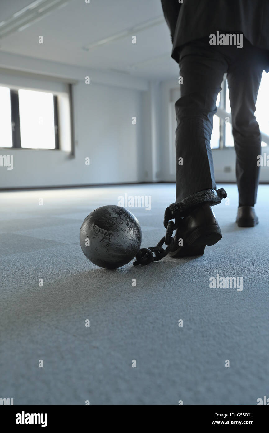 Japanese businessman with ball and chain Stock Photo Alamy
