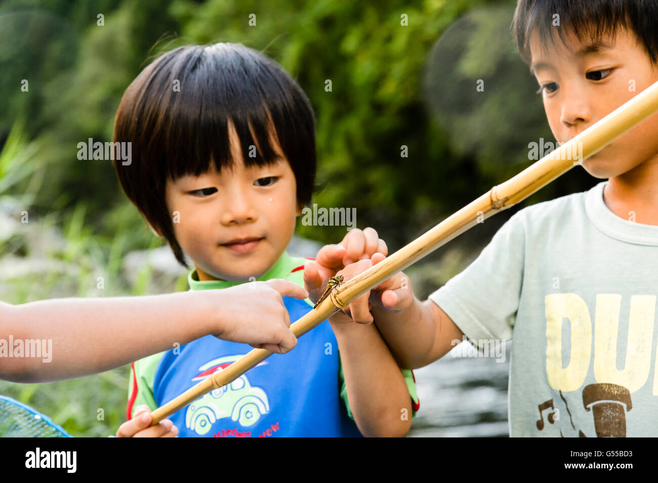 Japanese kids playing at the river Stock Photo