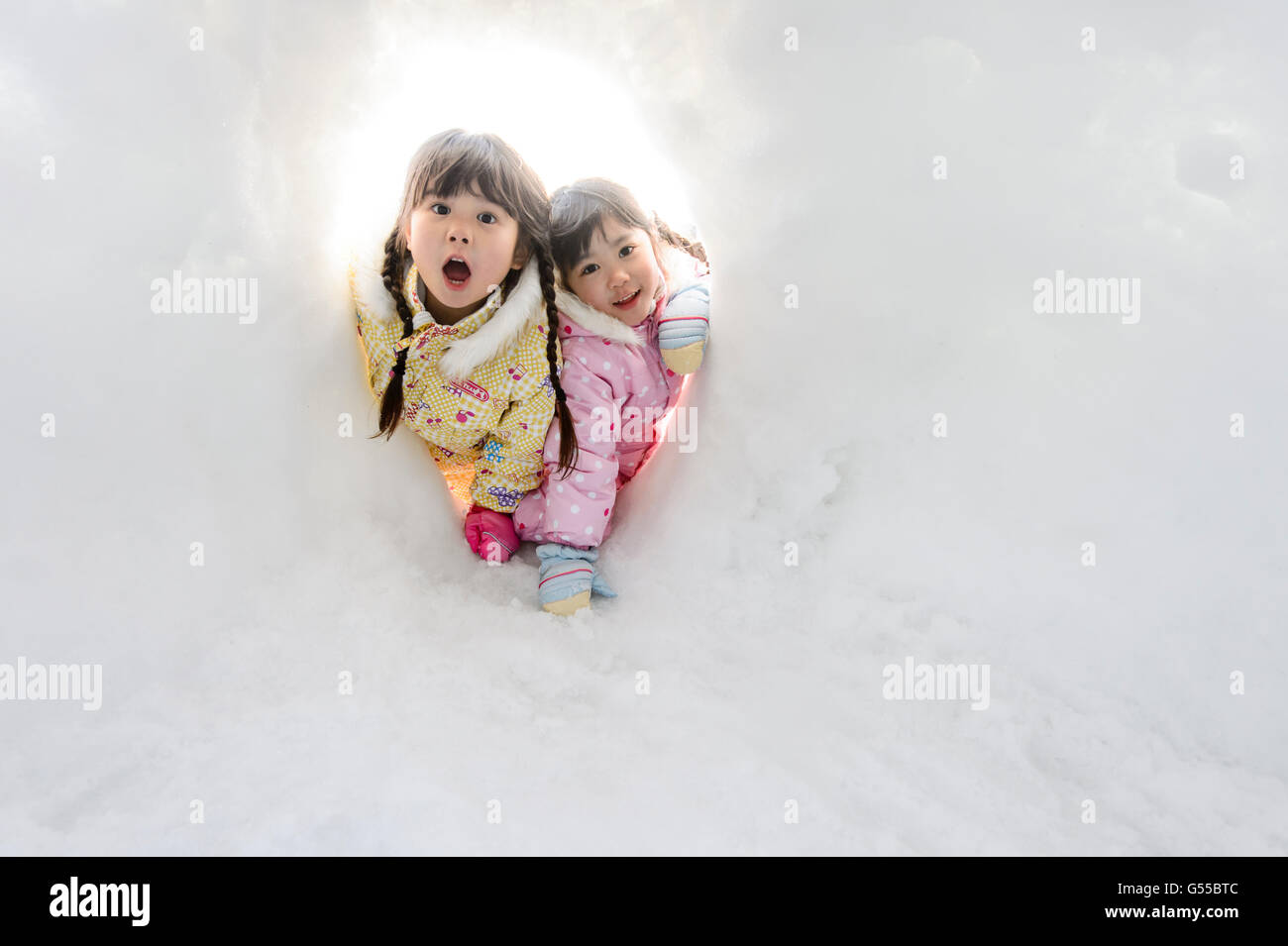Kids playing in the snow Stock Photo