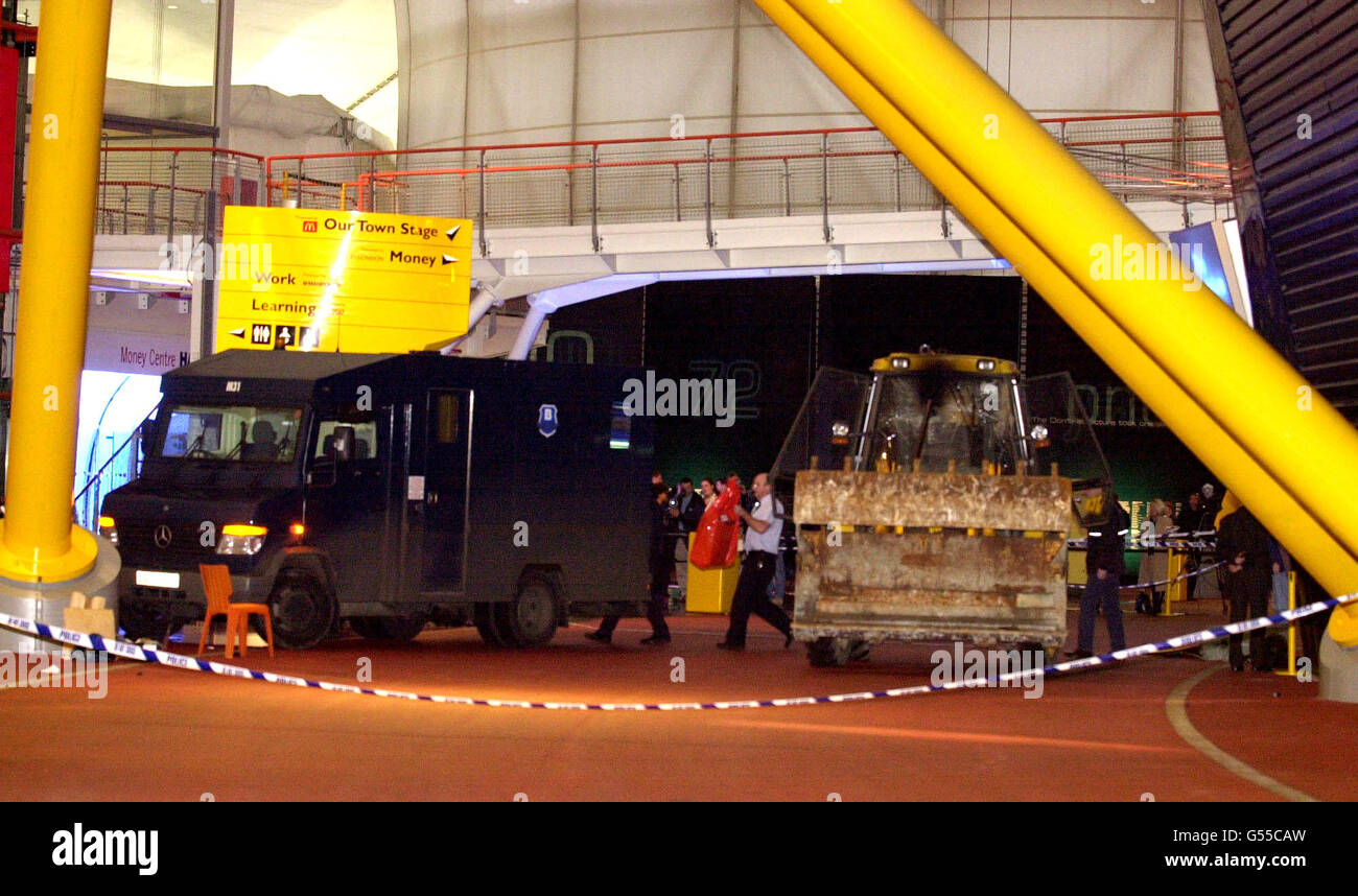 An armoured van being loaded by police, after a foiled raid on a diamond display in The Millennium Dome at Greenwich. Six people were arrested, including four in the Money zone vault, and two by the River Thames, where the robbers had a powerboat waiting to escape from the scene. *... The raiders used a bulldozer to break into the Dome, and had it been successful, it would have been the world's largest ever robbery. * 08/11/2001: Police foiled the "robbery" of the jewels when they caught raiders red handed as they smashed their way in using a mechanical digger, an Old Bailey court heard, at Stock Photo