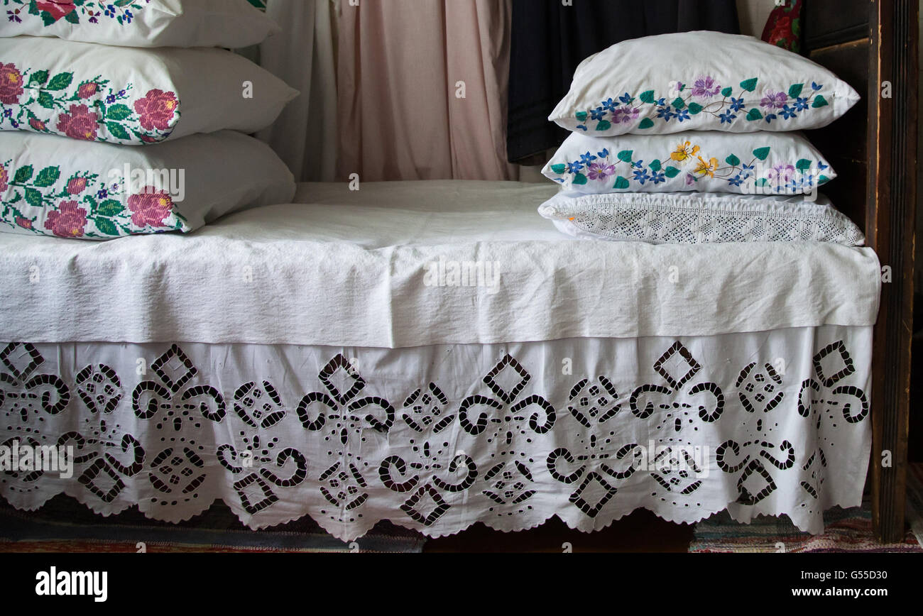 old style traditional bed with decorated bedding Stock Photo Alamy