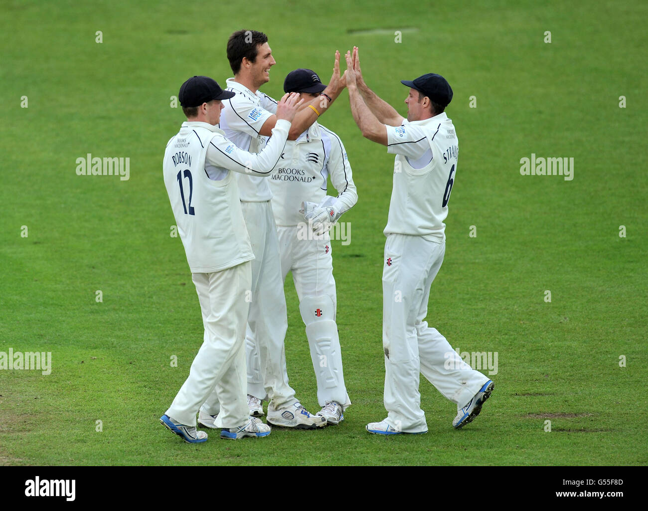 Middlesex's Steven Finn (second left) celebrates taking the wicket of Nottinghamshire's Stuart Broad caught by Middlesex's Andrew Strauss (right) during the LV= County Championship, Division One match at Trent Bridge, Nottingham. Stock Photo