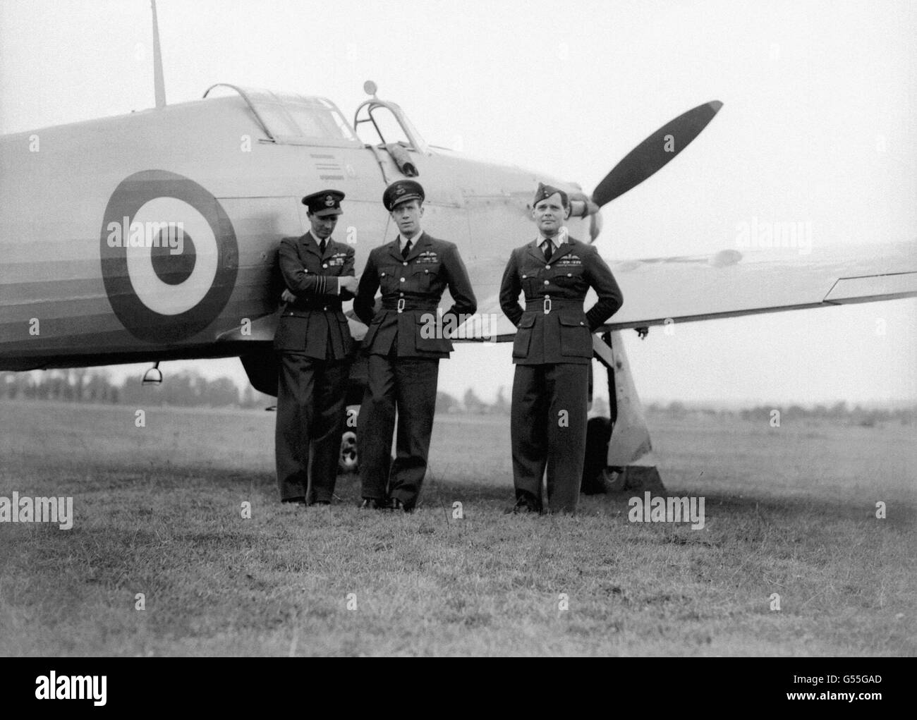 Group Captain Sir Douglas Bader (right)and two colleagues in front of a Mk1 Hawker Hurricane, one of the fighter aircraft he flew during World War II and which he is to fly during the Battle of Britain Day flight over London today. Despite losing both legs in 1931 he went on to down 22 enemy aircraft and leave the service as a Group Captain. He died in 1982. Stock Photo