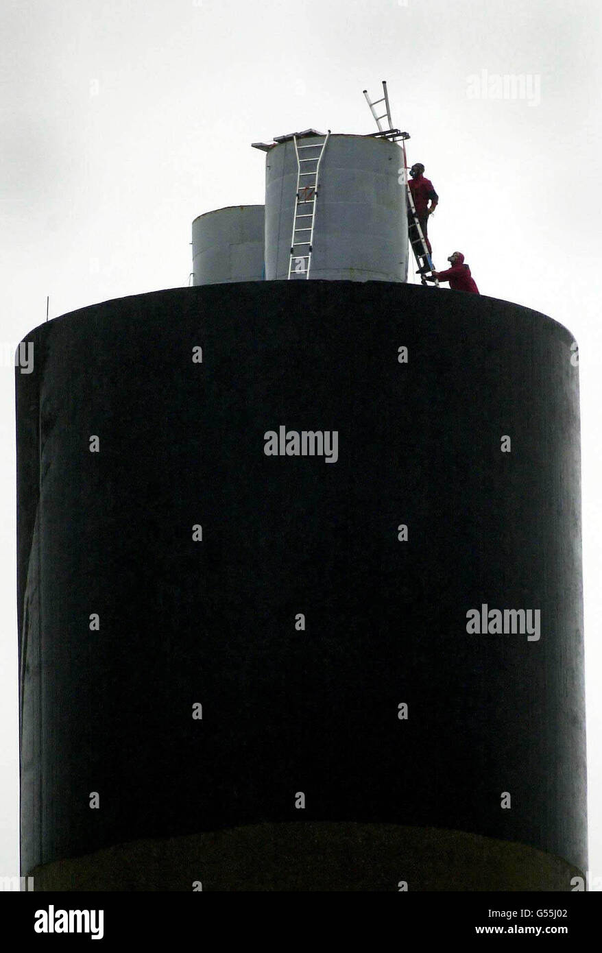 Activists from environment group Greenpeace who partially closed off one of the two 100 metre high exhaust chimneys at Britain's largest waste incinerator plant in Edmonton, north London, in protest over alleged toxic emissions. *The plant was forced to close after deliveries of refuse were blocked by protestors. Stock Photo