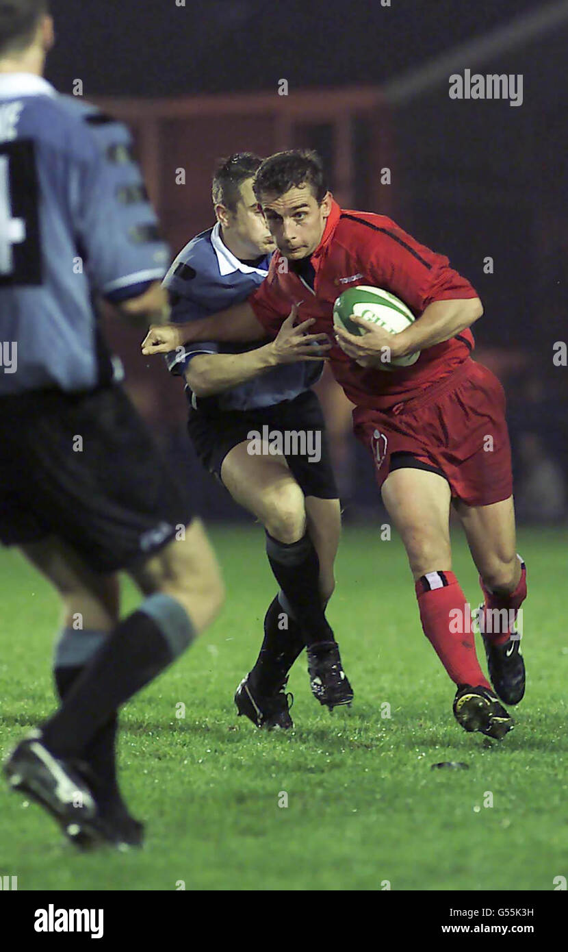Rhys Williams, fullback for Cardiff RFC (blue and black) tackles Michel Marfaing for Toulouse