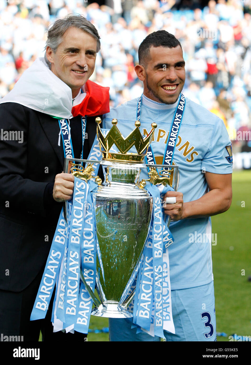 Manchester City Manager Roberto Mancini holds the premier league title