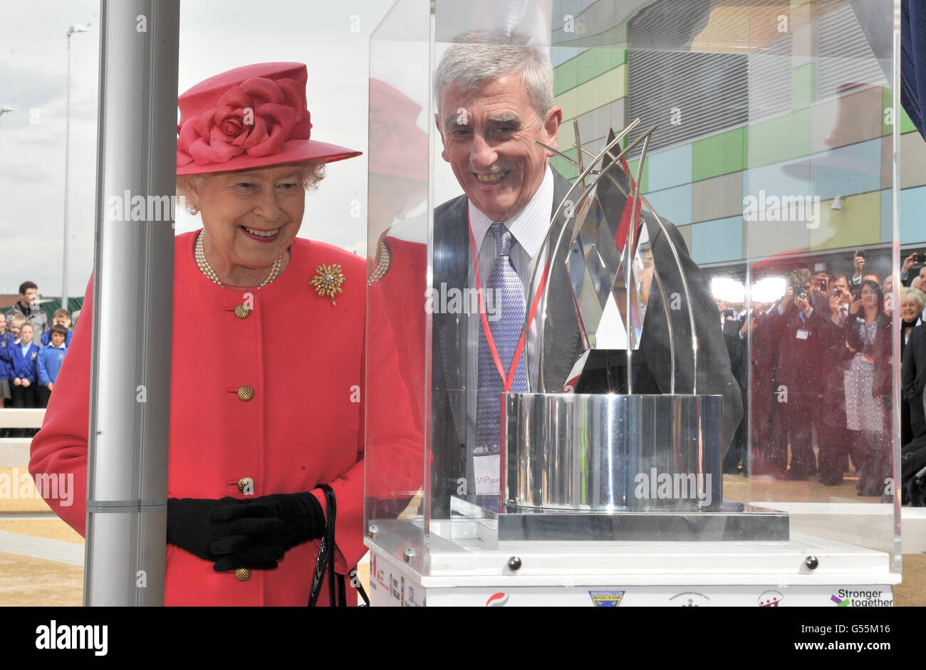 Queen Elizabeth II unveils a sculpture during her visit to Orford Jubilee Park with Cllr Terry O'Neil leader of Warrington Borough Council, Warrington as part of her visit to the north west. Stock Photo