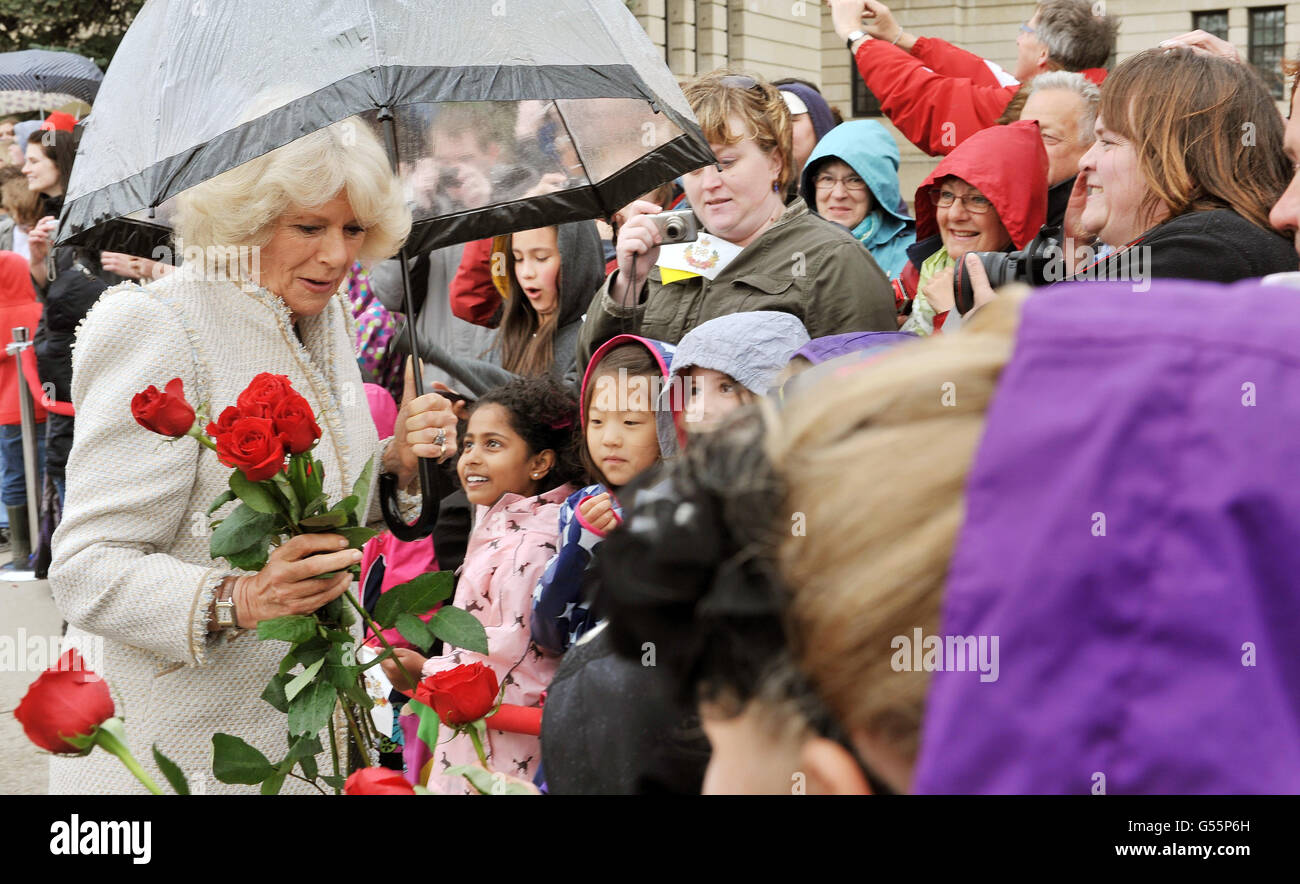 The Duchess of Cornwall is given flowers by children on her arrival at the Saskatchewan Legislative Building, in Regina, on the final day of a Diamond Jubilee tour of Canada. Stock Photo