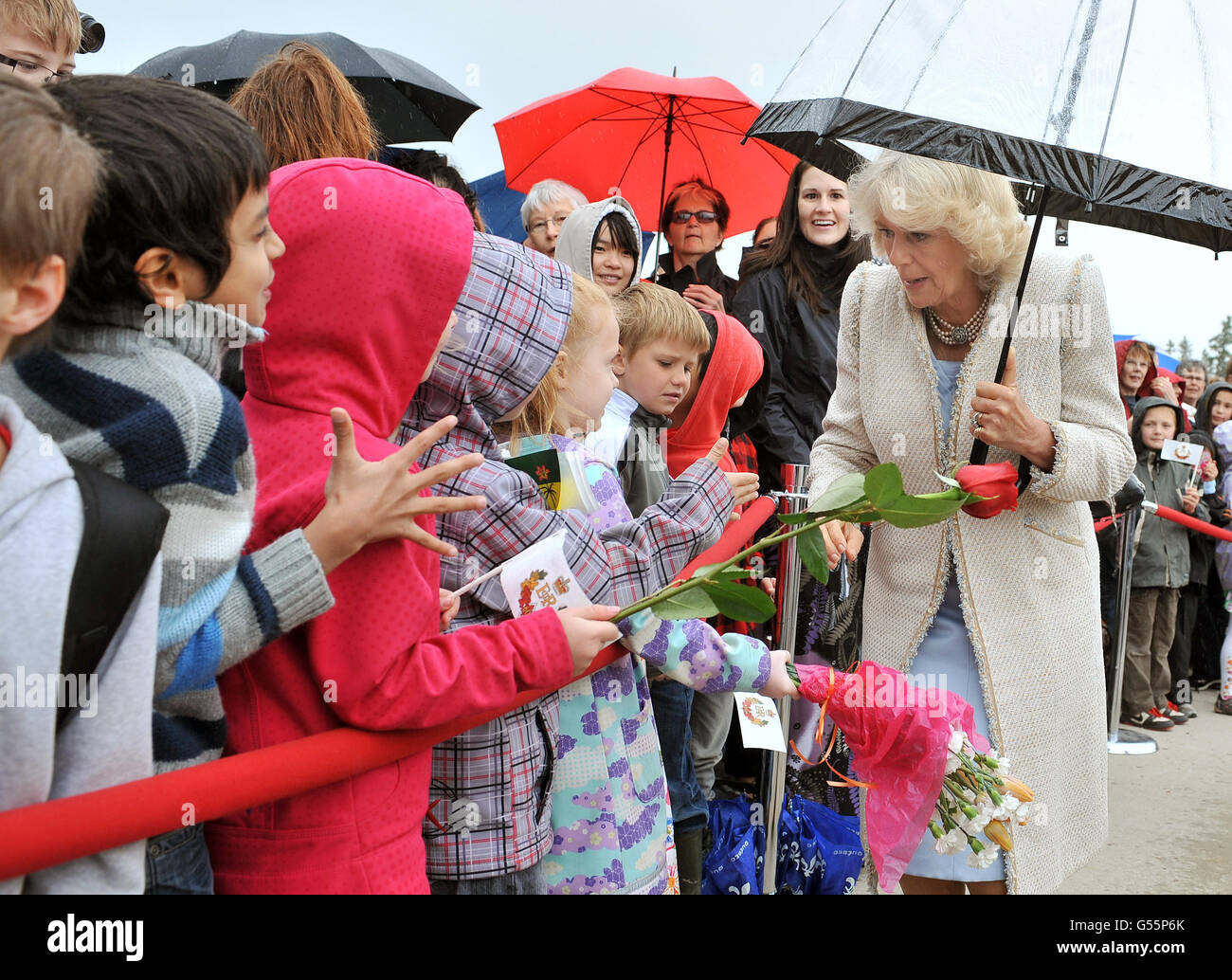 The Duchess of Cornwall is given flowers by children on her arrival at the Saskatchewan Legislative Building, in Regina, on the final day of a Diamond Jubilee tour of Canada. Stock Photo
