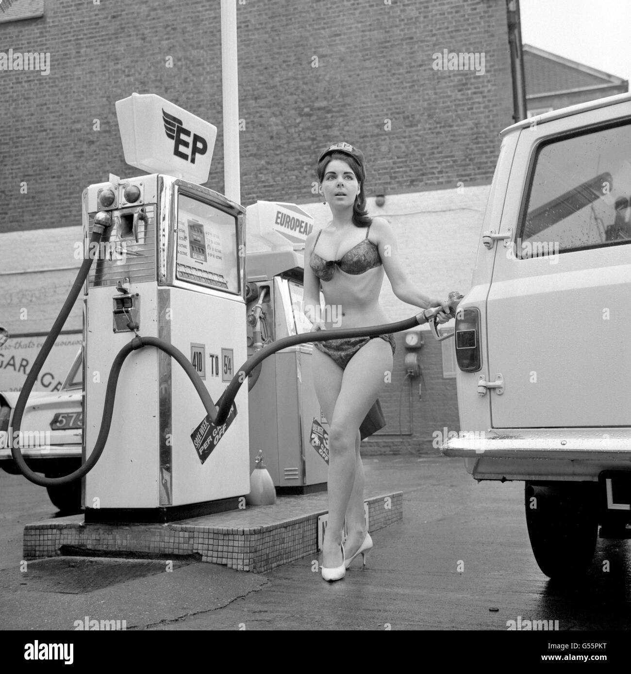Bikini clad British Petroleum pump attendant Vicky Hughes fills up a motorist vehicles with fuel at Empire Garage, London Stock Photo