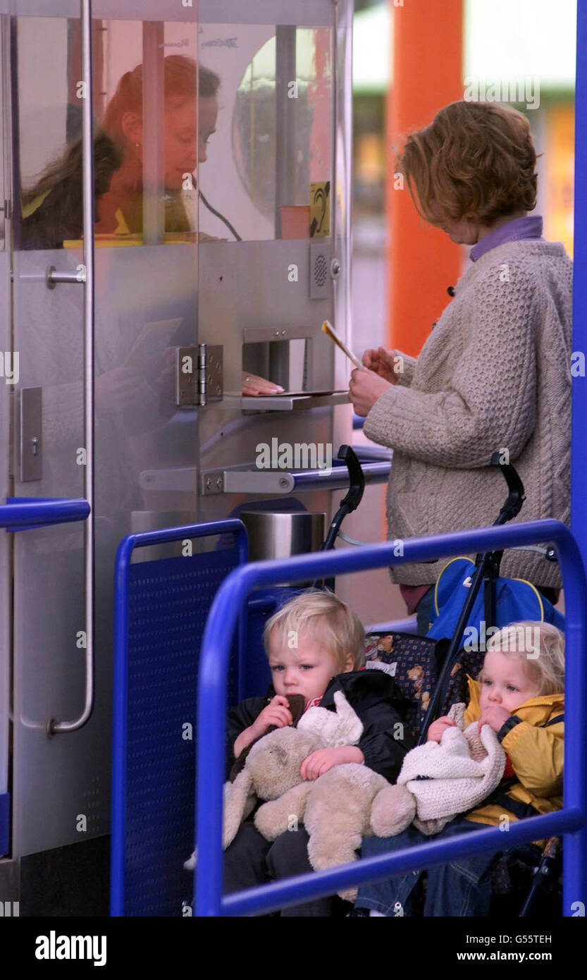 Visitor with two toddlers collects her ticket for the Millennium Dome. A damning offical report said the Dome was badly managed, with 'risky' visitor number targets and 'weak' financial management. *... The National Audit Office report into the Dome sets out a catalogue of management failures. Stock Photo