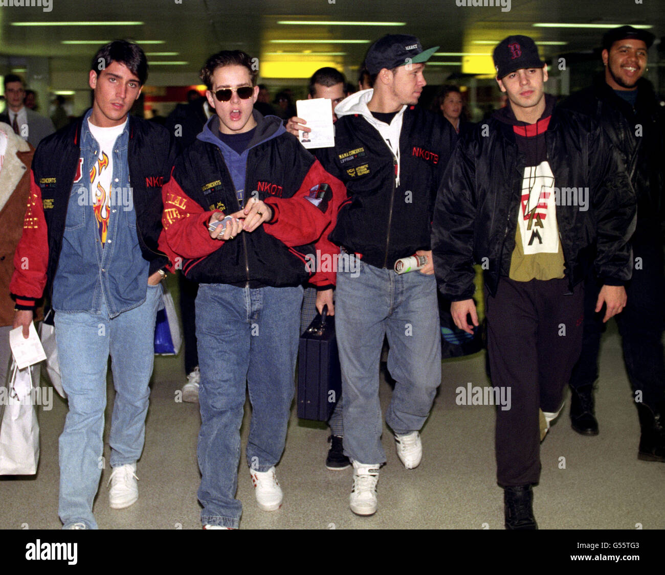 Four of the five members of American pop group New Kids on the Block arriving at London's Heathrow Airport from Vienna. L-R: Jon Knight, Joey McIntyre, Donnie Wahlberg and Jordan Knight. Stock Photo