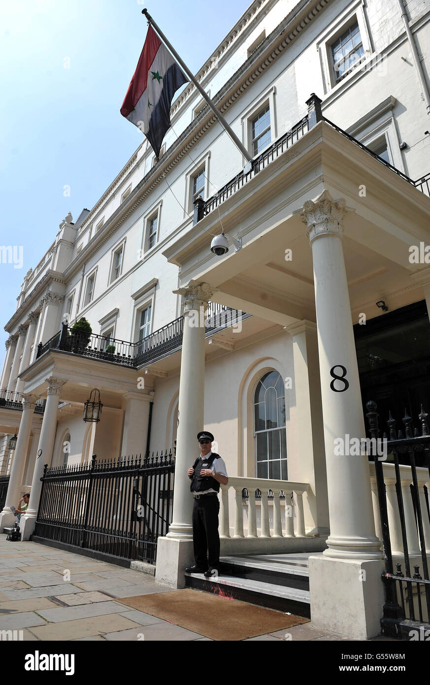 A police officer stands guard outside the Embassy of the Syrian Arab Republic in central London as Syria's Charge D'Affaires is being expelled from Britain along with two other diplomats. Stock Photo