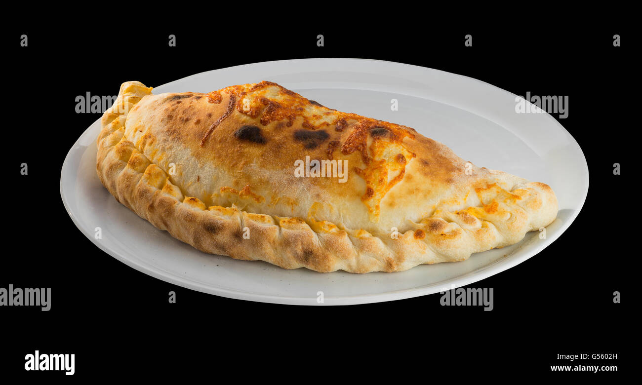 Classic Italian pizza KALZONE with yellow cheese, vegetables, mozzarella, tomato and sausage Stock Photo