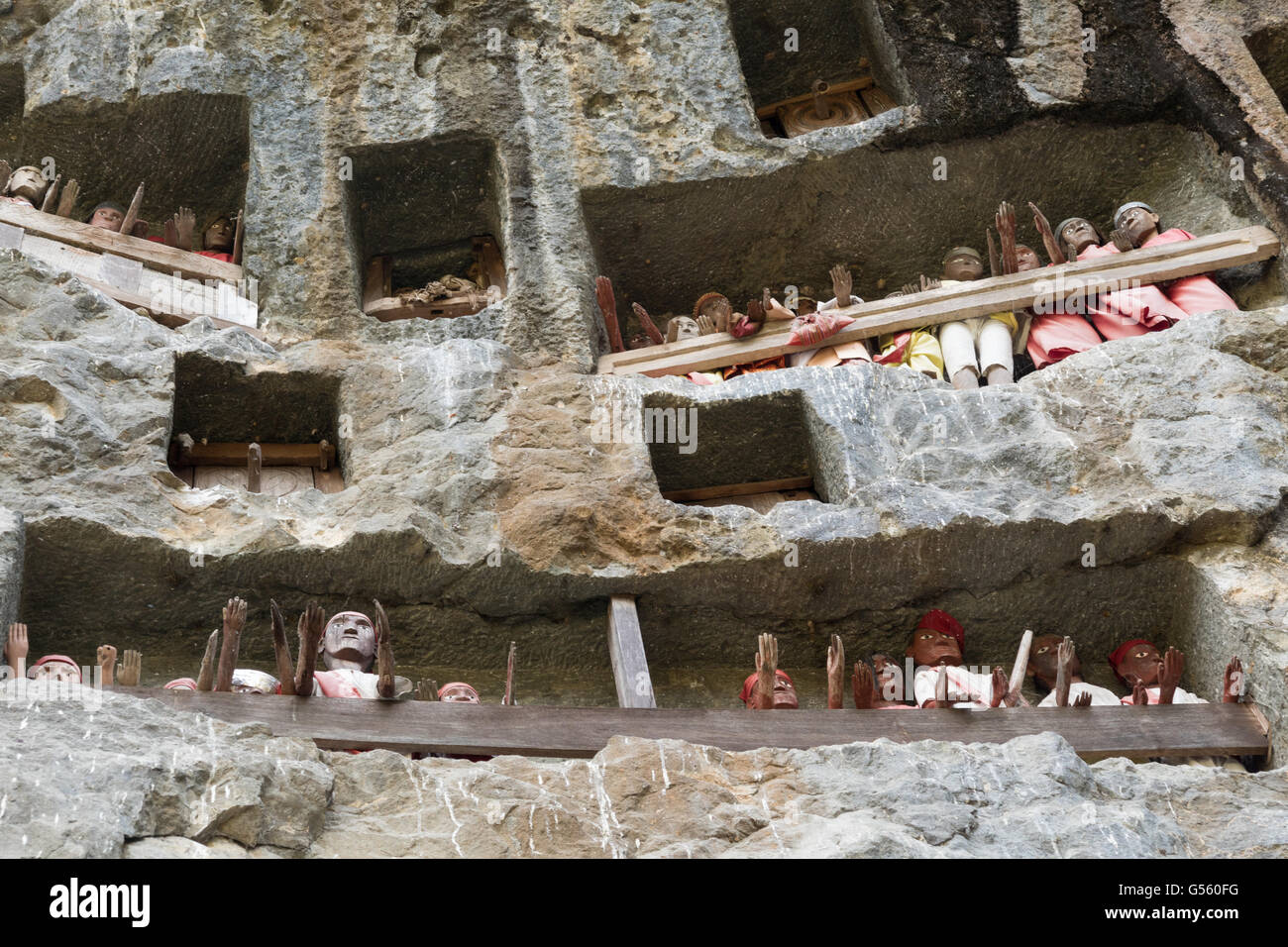 Indonesia, Sulawesi Selatan, Tana Toraja, Torajaland, wooden figures and rock tombs, dew are carved wooden figures, rock tombs, death cult Stock Photo