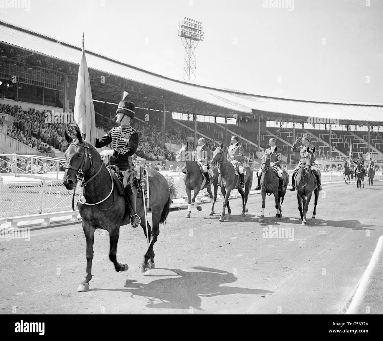The Swedish team trots in front of spectators at the International Horse Show Stock Photo
