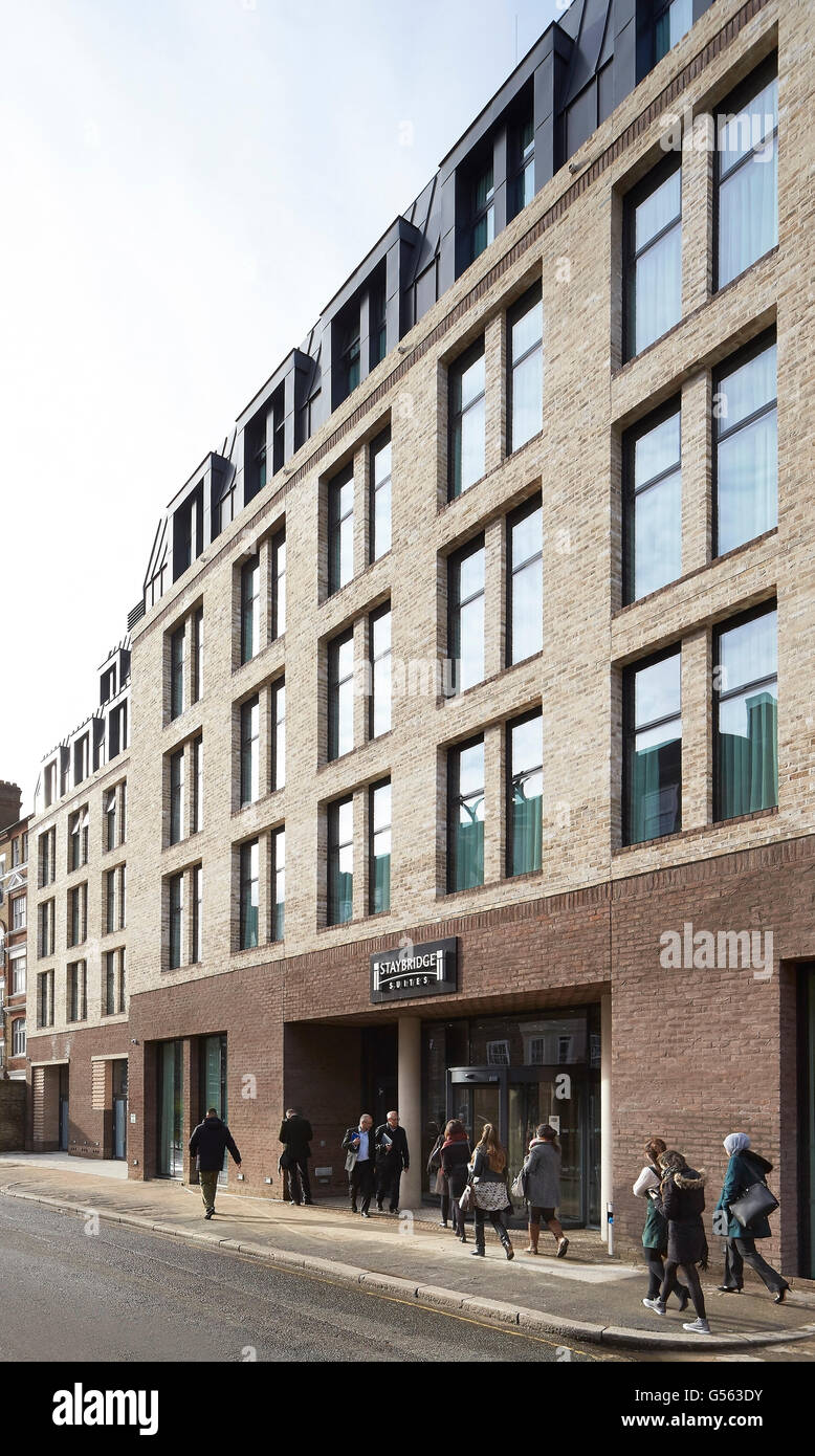 Brickwork facade and street perspective with passersby. Spring Mews, London, United Kingdom. Architect: The Manser Practice, 2015. Stock Photo