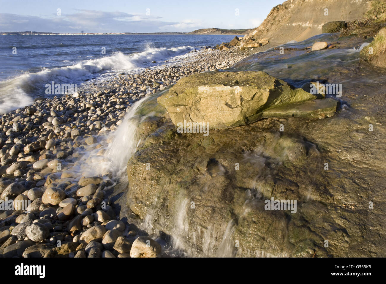 Waterfall on rocky beach, Osmington, Dorset, England, January Stock Photo