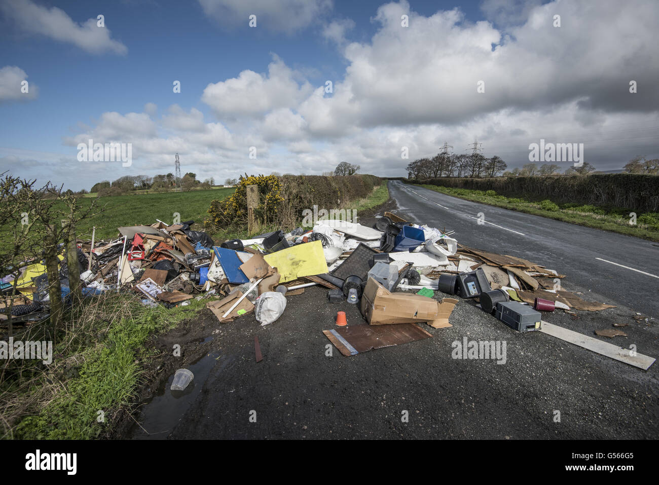 Lorry load of rubbish fly-tipped in farm gateway, Inglewhite, Preston, Lancashire, England, April Stock Photo