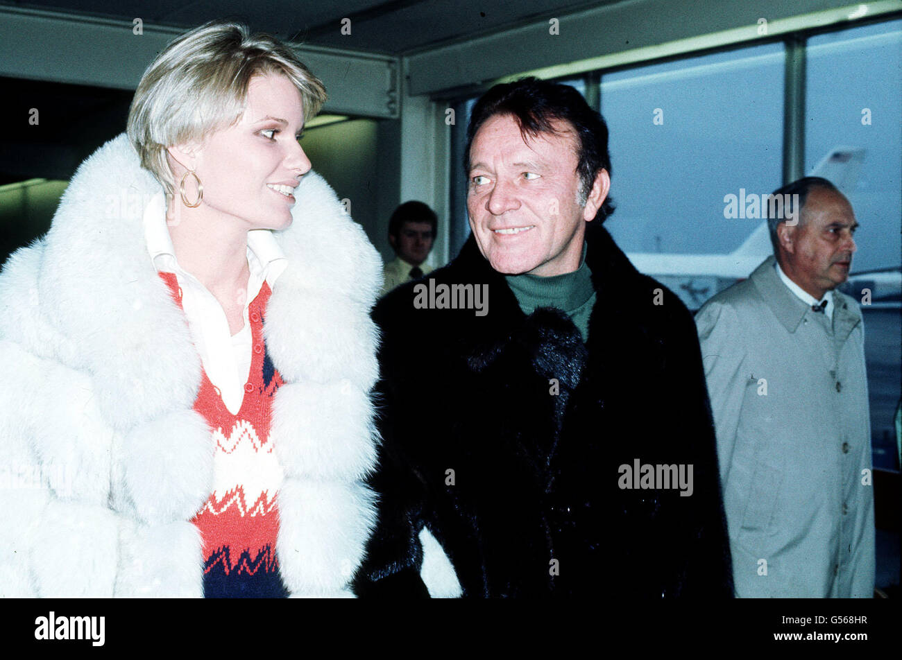 Richard Burton and his wife Suzy, former wife of World champion racing driver James Hunt, at Heathrow Airport after they arrived from Canada. Stock Photo