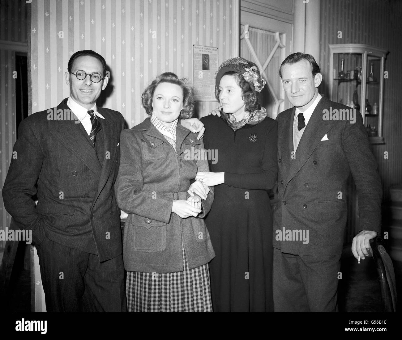 Left to right, Captain Peter Churchill, Anna Neagle, Odette Churchill, and Trevor Howard at Borehamwood on the set of 'Odette, G.C'. The film is based on the wartime exploits of Mrs Churchill - then Mrs Odette Sansom - who was awarded the George Cross for her work as a British secret agent in occupied France. She was tortured by the Gestapo when she refused to betray her commanding officer, Captain Peter Churchill (whom she married afterwards). In the film the part is played by Anna Neagle and the part of Captain Churchill is played by Trevor Howard. Stock Photo
