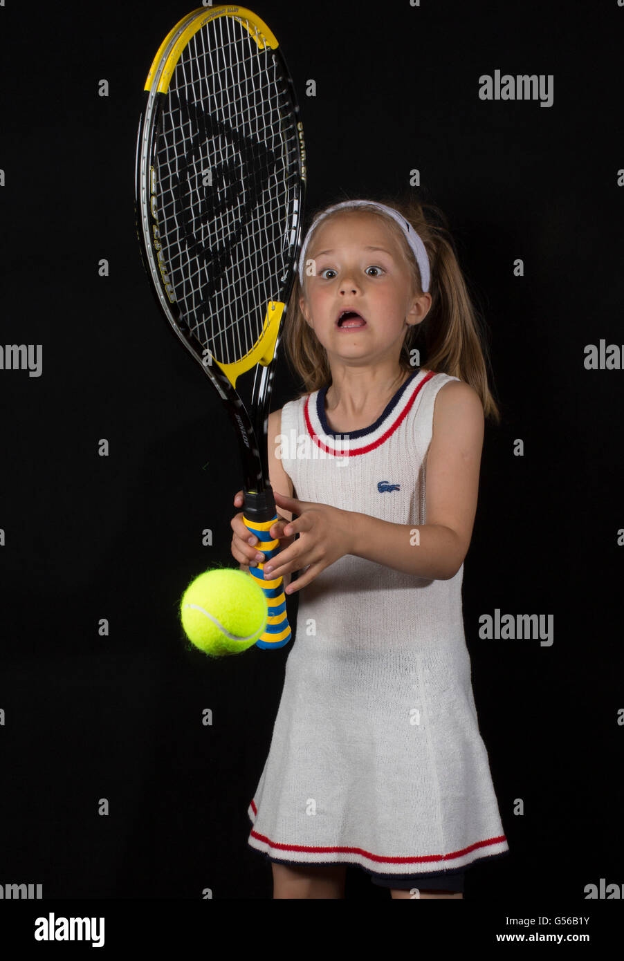 humorous portrait of a young girl playing tennis Stock Photo
