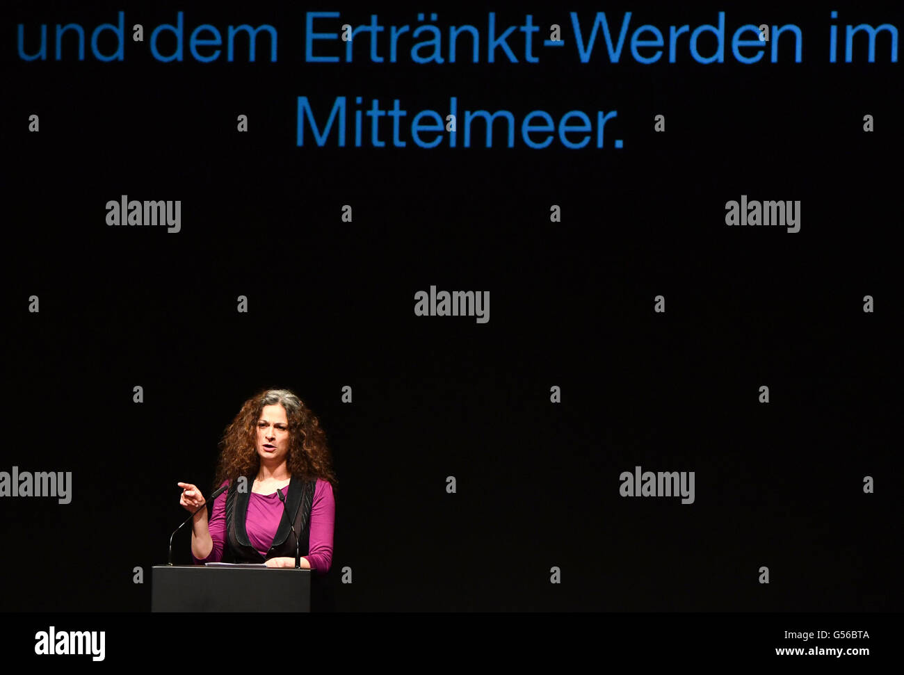 Actor May Skaf threatens to feed herself to tigers of the German government won't make a political stance, as a part of the art action 'Feeding on Refugees' at Maxim Gorki theater in Berlin, Germany, 20 June 2016. She is a refugee from Syria and calls for an end of the many deaths of refugees on the Mediterranean Sea. The action aims at a change of the residence law, which currently prohibits the transportation of foreigners without papers. Photo: Jens Kalaene/dpa Stock Photo