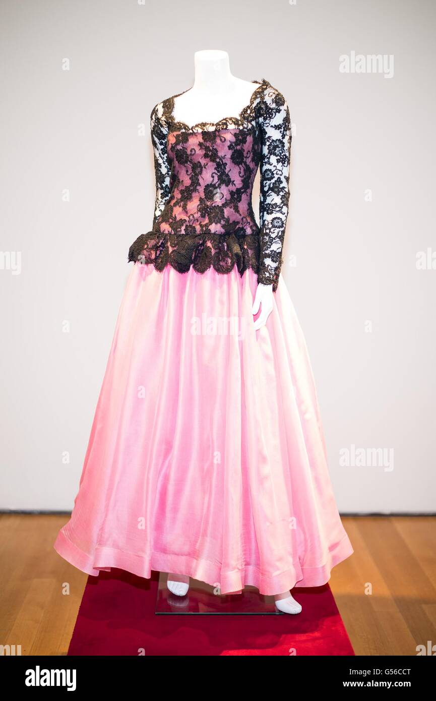 New York, NY, USA. 19th June, 2016. A BLACK LACE AND PINK SILK LINEN EVENING GOWN With sheer black lace sleeves, neck and waist overlaying a pink bodice and tulle-lined full skirt, with labels Oscar de la Renta and Grace Costumes New York inside for Collection of Joan Rivers Press Preview, Christie's Auction House, New York, NY June 19, 2016. Credit:  Steven Ferdman/Everett Collection/Alamy Live News Stock Photo