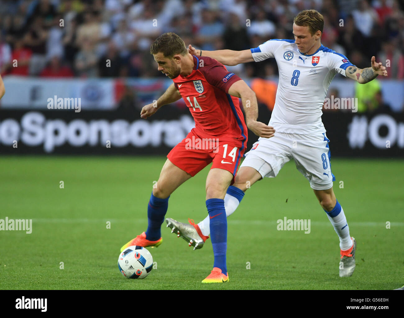 Saint Etienne, France. 20th June, 2016.  Jordan Henderson(L) of England vies with Ondrej Duda of Slovakia during their Euro 2016 Group B soccer match in Saint-Etienne, France, June 21, 2016. Credit:  Xinhua/Alamy Live News Stock Photo