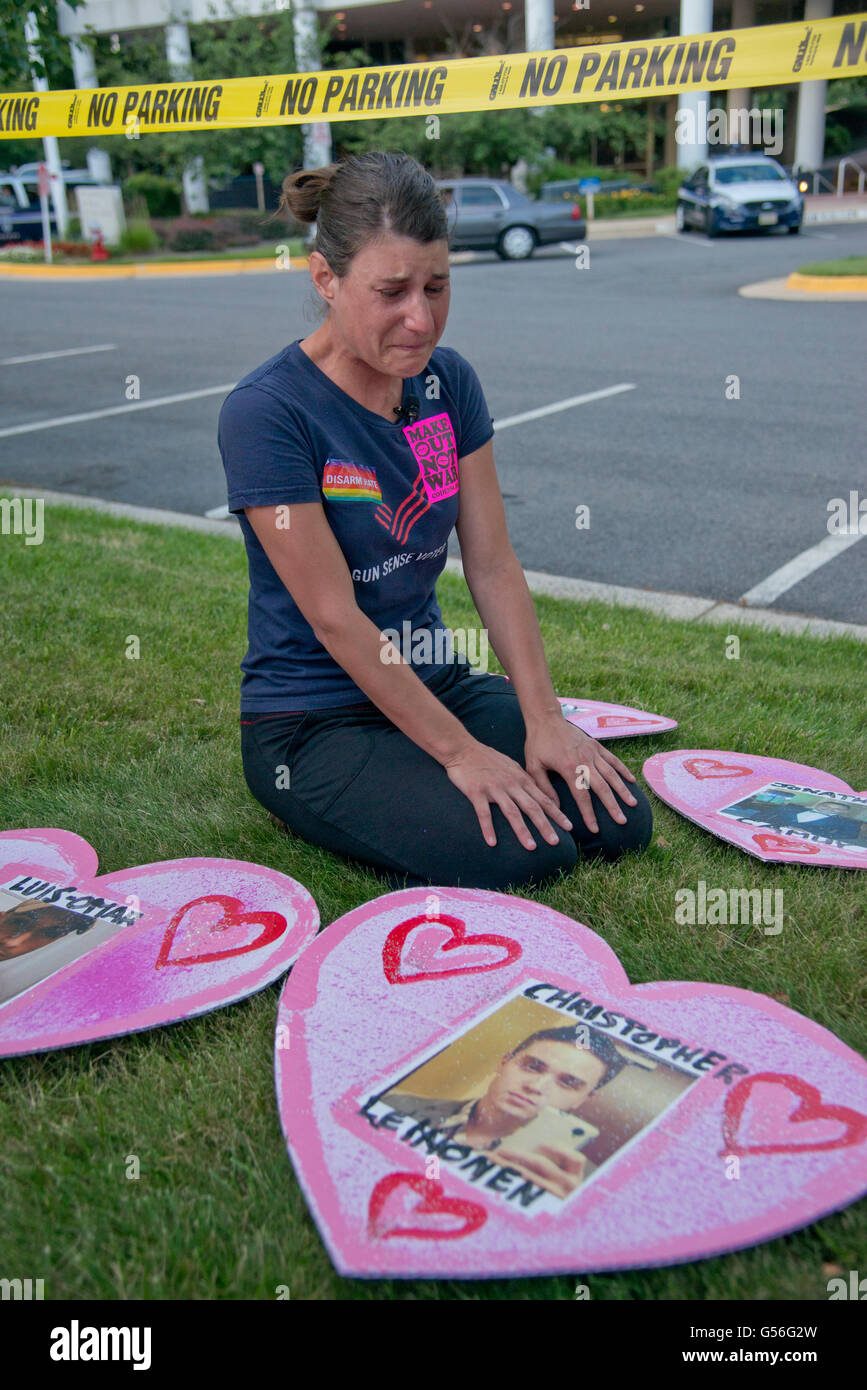 Fairfax, VA, USA. 20th June, 2016. USA--Mandy Tamoff cries as she looks on at one of the faces of the Orlando, Florida shooting. Pro and anti gun rights activists gather at the headquarters of the National Rife Association (NRA) to show their support for and against gun control. Credit:  Patsy Lynch/Alamy Live News Stock Photo