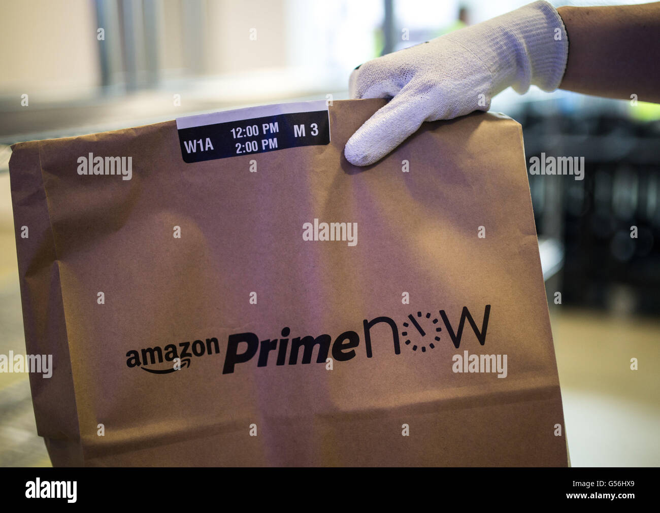 An Amazon Prime Now Employee Holds A Bag Ready To Be Shipped In The Stock Photo Alamy