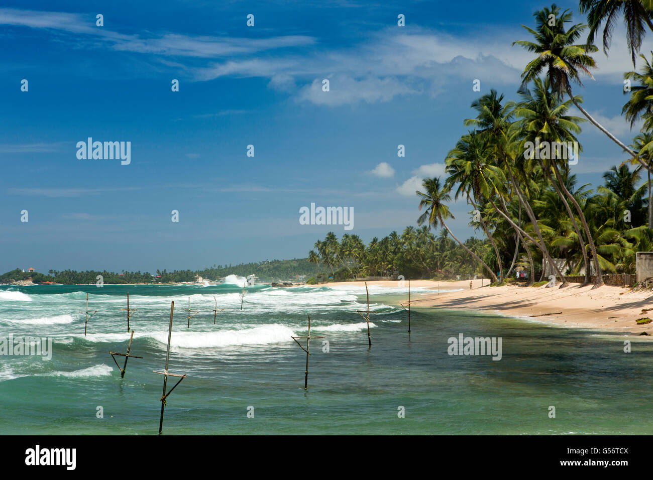Sri Lanka, Galle Province, Unawatuna, Thalpe, Wijaya, stilt fishermen’s poles in water Stock Photo