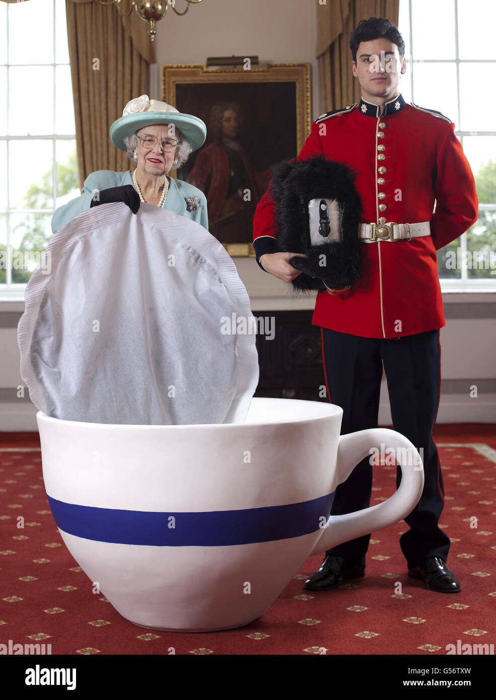 Queen Elizabeth look-alike, Elizabeth Richard, poses with a giant tea bag  to launch Tetley Tea's limited edition 60 person street party tea bag to  coincide with the Jubilee celebrations, at the Royal