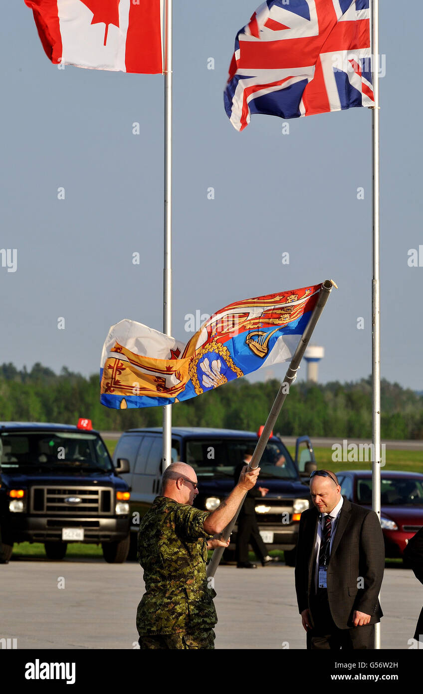 The new Canadian Flag of the Prince of Wales flies is prepared to be hoisted up at Fredericton International Airport, where the Prince and the Duchess of Cornwall start a four day Diamond Jubilee tour of the north American country. Stock Photo