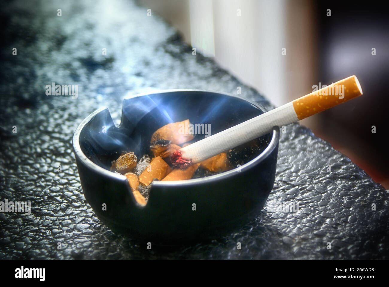 Photograph of a cigarette and an asher Stock Photo