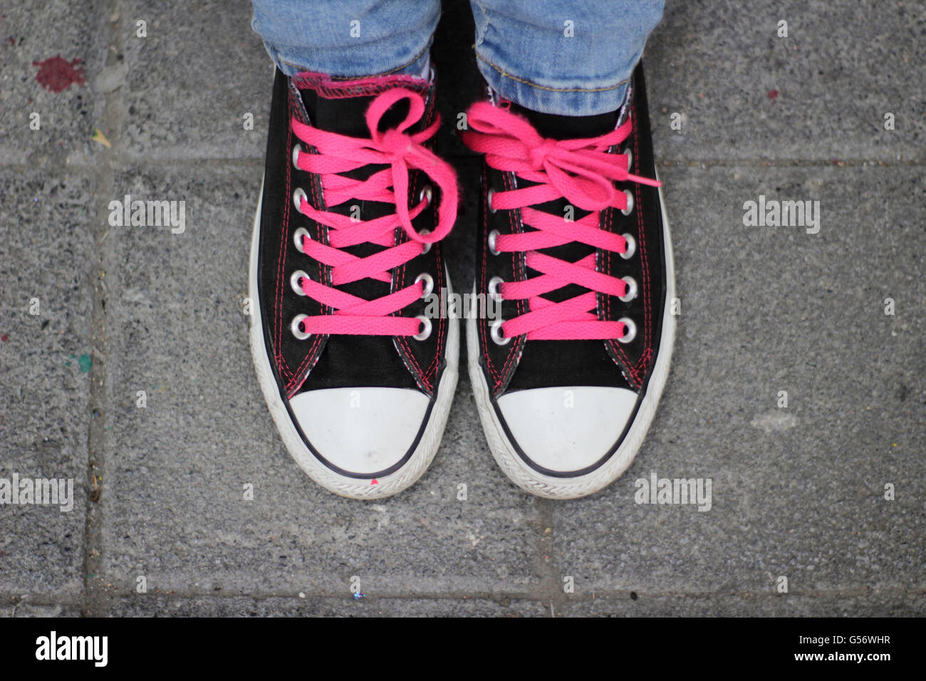 Photograph of a pair of classic tennis shoes and jeans Stock Photo