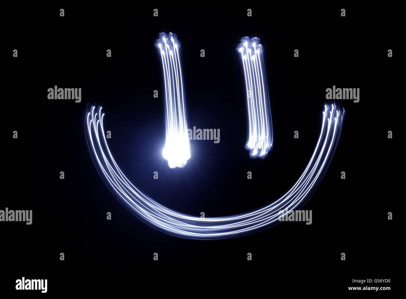 Photograph of a happy face drawing made with long exposure light effect Stock Photo