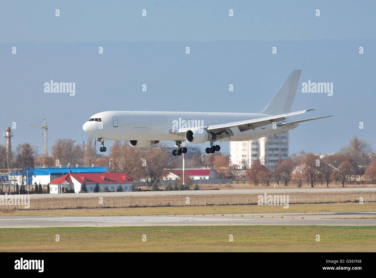 Cargo plane landing on the airport runway Stock Photo