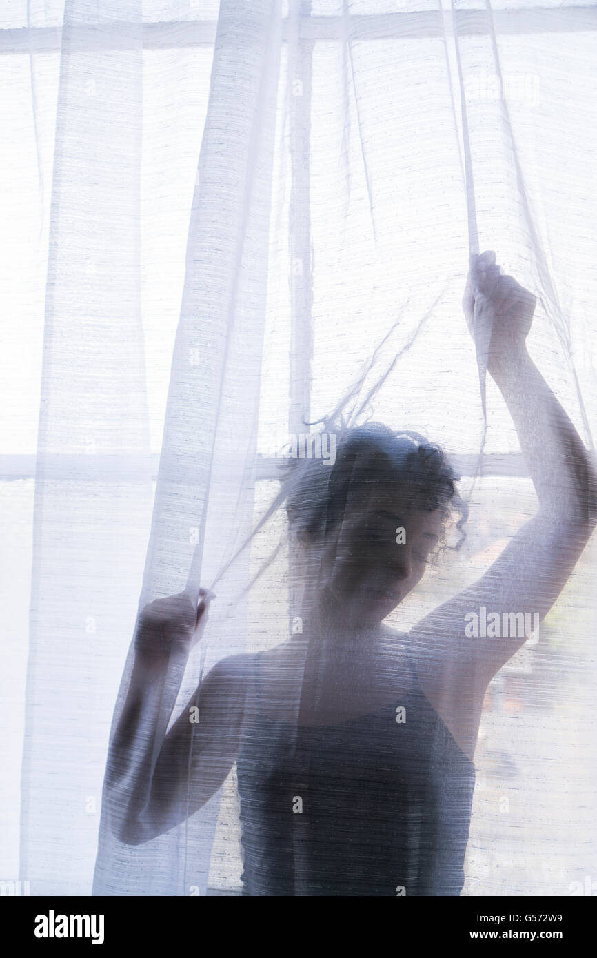 Woman by the window Stock Photo
