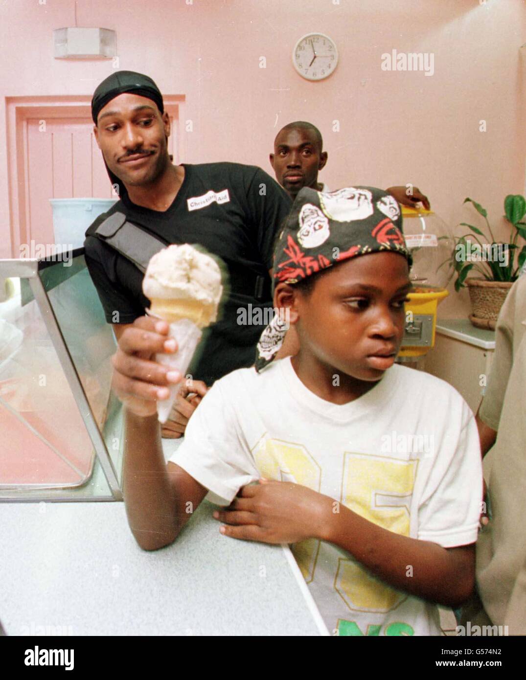 Channel Four gameshow Big Brother contestant Darren Ramsey (L) buying ice cream with inner city children from Hope for Children development company, Mandela Project in Kingston, Jamaica. *...Ramsay abandoned his role as a goodwill ambassador for charity Christian Aid in Jamaica hours before he was due to give a speech on World Aids Day. The 23-year-old father of three flew home early from a four-day mission complaining of exhaustion, to the anger of charity workers. Stock Photo