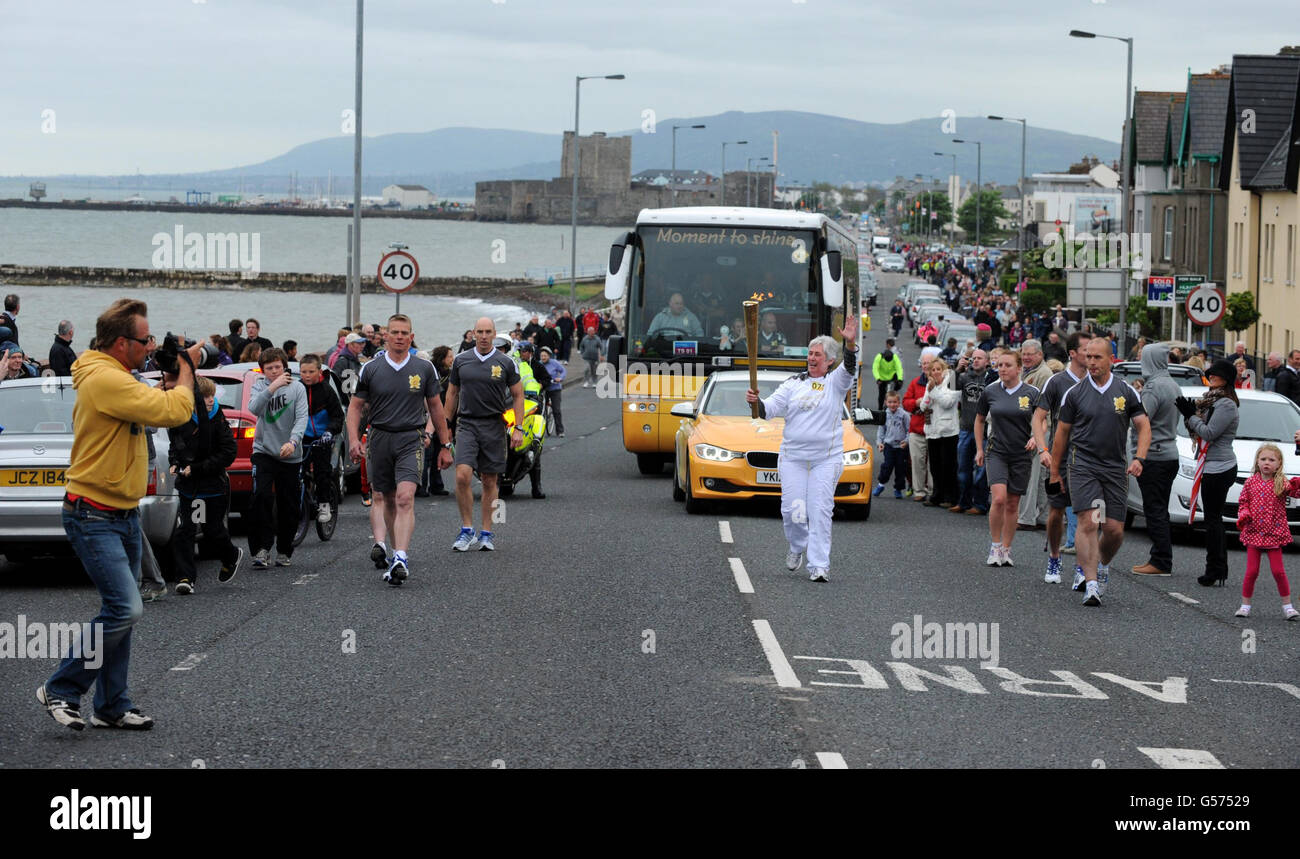 Torchbearer 078 Bernadine Mcdonald carries the Olympic Flame on the Torch Relay leg through Carrickfergus. The Torchbearer's name is provided in good faith, however the Press Association has been unable to verify it independently. Stock Photo