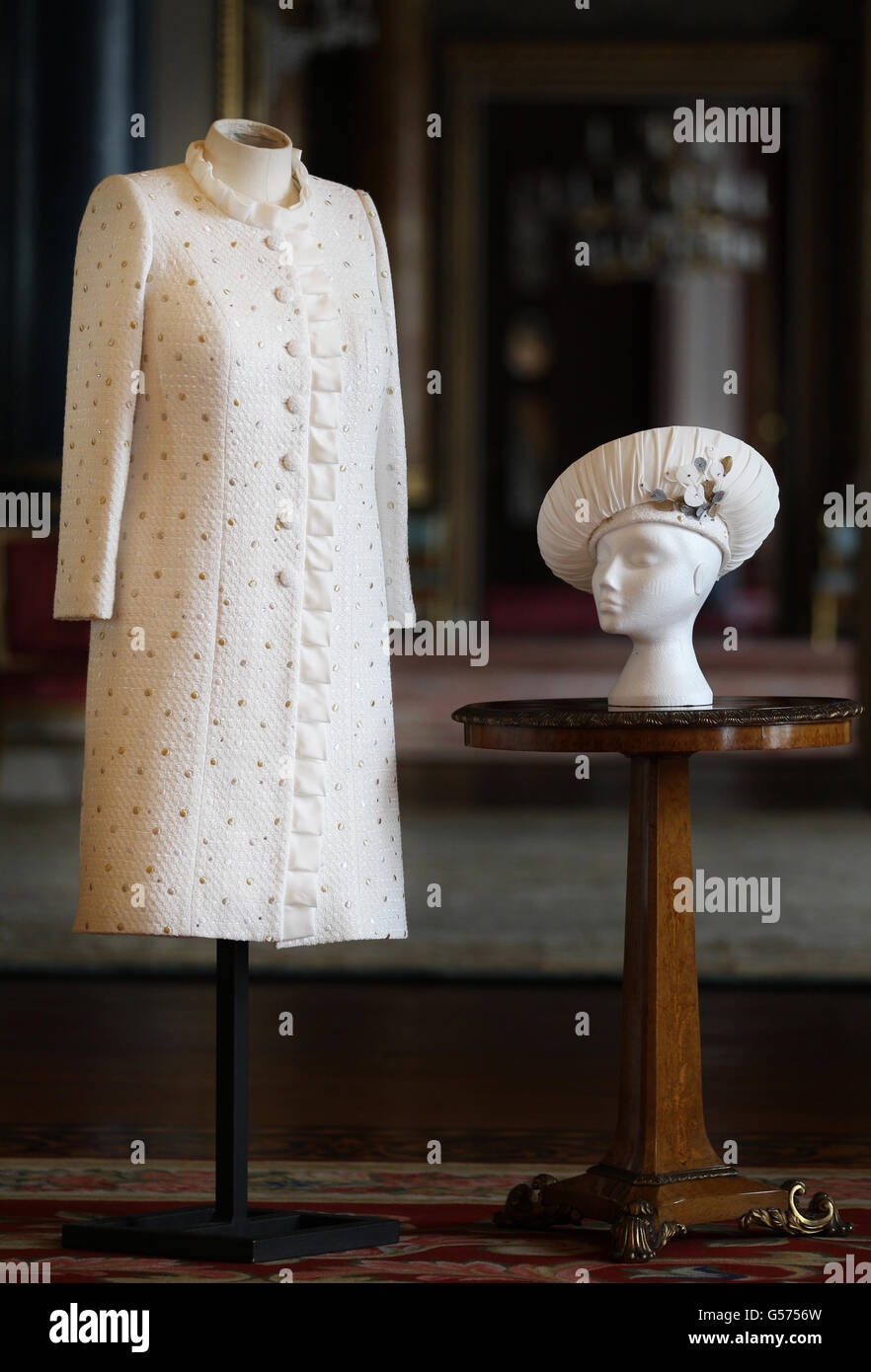 Previously unreleased photo of the ivory dress and coat, in white Boucle fabric and threaded throughout with silk ribbon, designed by Miss Angela Kelly MVO, which Queen Elizabeth II has worn for the Thames Diamond Jubilee Pageant. Stock Photo