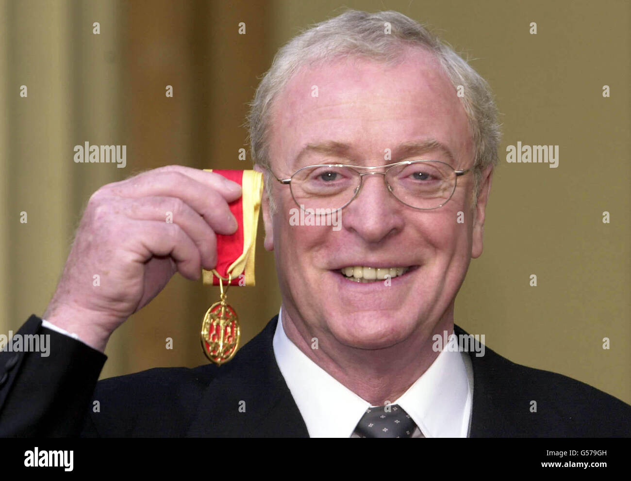 Actor Michael Caine at Buckingham Palace in London, after receiving a knighthood from Britain's Queen Elizabeth II. Knighted as Sir Maurice Micklewhite - his real name. *...the Bermondsey-born son of a Billingsgate fish porter and London charwoman remains a prolific movie actor whose portrayals include the bespectacled Harry Palmer in the Len Deighton spy thrillers, Cockney Lothario Alfie Elkins in Alfie, and Charlie Croker in The Italian Job. Stock Photo