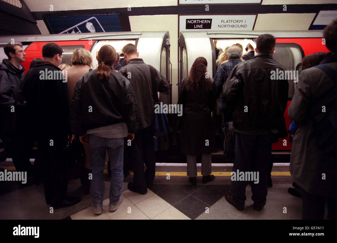 Passengers waiting to board a London underground train. 20/12/00: Underground has become a premier film location, providing backdrops for many leading releases, a new report showed. More than 200 requests to shoot scenes in Tube stations have been received. * this year alone. Film-makers have gone underground to record scenes for a number of top films including Superman IV, Mission Impossible, Sliding Doors, The End of The Affair and this summer's blockbuster, Billy Elliot. Some of the longer scenes have had to be filmed at night or in stations which are closed at weekends to avoid disruption Stock Photo